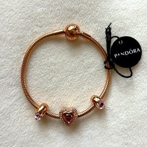 Pandora 14k plated rose gold bracelet with 1 heart charm and 2 clips. NWT